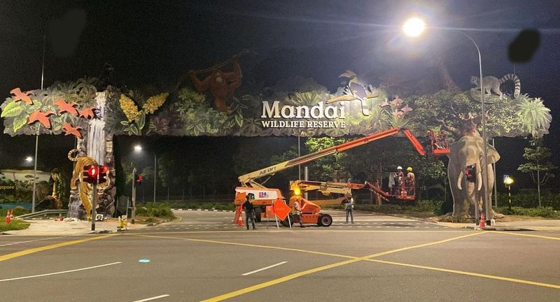 Seng Soon crew on boom lifts installing lightning protection at the Mandai Wildlife Reserve entrance portal at night